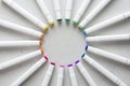 A set of bright multi-colored felt-tip pens or markers lie in a circle, rays, creating a round frame in the center. Creativity,