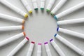 A set of bright multi-colored felt-tip pens or markers lie in a circle, rays, creating a round frame in the center. Creativity,