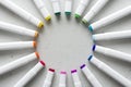 A set of bright multi-colored felt-tip pens or markers lie in a circle, rays, creating a round frame in the center. Creativity,