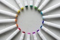 A set of bright multi-colored felt-tip pens or markers lie in a circle, rays, creating a round frame in the center. Creativity,