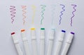 A set of bright multi-colored felt-tip pens or markers lie on white background sheet of paper, with samples of drawing. Creativity Royalty Free Stock Photo
