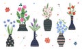 Set of bright spring flowers in vases and bottles isolated on a white background. Cartoon flat vector illustration. Royalty Free Stock Photo