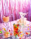 Set of bright sweet cocktails on a pink shiny background with glitter and soap bubbles. Royalty Free Stock Photo