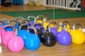 Set of brightly colored kettle weights in a gym