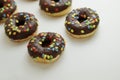 Set of Brown chocolate donut decorated with smarties isolated on white background side view. Fried dough confection, dessert food Royalty Free Stock Photo