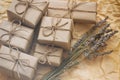 Set of brown gift boxes. Wrapped in craft paper and tied by hemp cord. Old paper background. Small lavender bouquet. Royalty Free Stock Photo