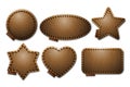 Set of brown leather label shapes with stitches. Leather patches with seam.