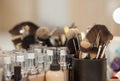 A set of brushes for make-up and tone the foundation for the person standing on the table in front of a mirror in a beauty salon.