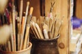 Set of brushes and painting tools on table in artist`s workshop Royalty Free Stock Photo