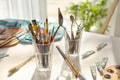 Set of brushes and painting tools on table in artist's workshop Royalty Free Stock Photo