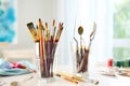 Set of brushes and painting tools on table in artist's workshop Royalty Free Stock Photo