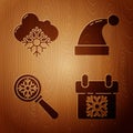 Set Calendar, Cloud with snow, Magnifying glass with snowflake and Christmas Santa Claus hat on wooden background Royalty Free Stock Photo