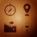 Set Campfire and pot, Compass, Mountains and Location on wooden background Royalty Free Stock Photo