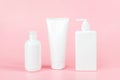 Set of care cosmetic for skin, body or hair. Three white blank cosmetics bottles, tube on pink background. Spa Cosmetic Beauty Royalty Free Stock Photo