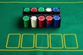 Set of cashino chips on green table Royalty Free Stock Photo