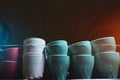 set of ceramic colored cups or mugs heating on professional coffee machine Royalty Free Stock Photo