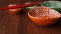 Set of ceramic dishes and red sushi sticks on wooden background Royalty Free Stock Photo