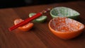 Set of ceramic dishes and red sushi sticks on wooden background Royalty Free Stock Photo