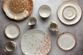 Set of ceramic round bowls, plates and sauce boats on a vintage grey background. Flat lay, top view Royalty Free Stock Photo
