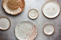 Set of ceramic round bowls and plates on vintage grey background. Flat lay Royalty Free Stock Photo