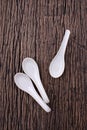 Set of ceramic spoon on wood background.