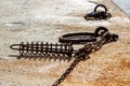 Set of chains, shackles, and whips on the edge of a rocky surface Royalty Free Stock Photo