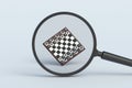 Set of chess figures behind magnifying glass Royalty Free Stock Photo