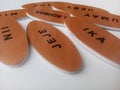 a set of chest names or emblems with different names in brown made of acrylic coated with pvc