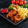 Set of chicken nuggets, salad and french fries Royalty Free Stock Photo