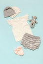 Set of children`s clothes on a blue background for the girl: a T-shirt, shorts, a selection of caps and socks. Collection Royalty Free Stock Photo