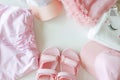 Set of children`s clothes for girls in pink style. Sandals, cap and t-shirt, flat lay, top view Royalty Free Stock Photo