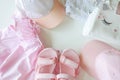 Set of children`s clothes for girls in pink style. Sandals, cap and t-shirt, flat lay, top view Royalty Free Stock Photo