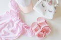 Set of children`s clothes for girls in pink style. Sandals, cap and t-shirt, flat lay, top view Royalty Free Stock Photo