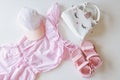 Set of children`s clothes for girls in pink style. Sandals, cap and t-shirt, flat lay, top view Royalty Free Stock Photo