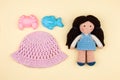 Set - children`s panama, toys for sand, amigurumi dolls with brown hair. The concept of vacations, games in kindergarten.