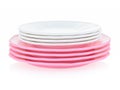 A set of children`s tableware made of pink plastic on a white background. Toy plates and saucers, children`s service. Toys for Royalty Free Stock Photo