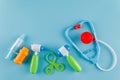 A set for children to play doctor, a game set, a toy stethoscope, a syringe, a hammer, spikes, pills, on a blue Royalty Free Stock Photo