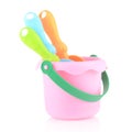 A set of children's toys for playing in the sandbox. Colored rake, shovel and bucket made of plastic, isolated Royalty Free Stock Photo