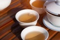 Set of Chinese green tea on a wooden table. Tree cups on a brown table