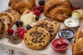 Set of chocolate croissants and cookies with syrups  decorated with berries Royalty Free Stock Photo