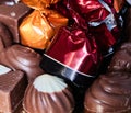 Set of chocolates with one wrapped in bright maroon foil Royalty Free Stock Photo