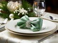 set of Christmas laid table, green bow luxurious plates, silver cutlery, Christmas dinner or New Year\'s Eve party Royalty Free Stock Photo