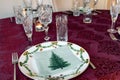 Set Christmas table with Christmas plate and crystal glasses.