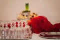 Set Christmas table with a white tablecloth, silver platters, many wine glasses, red fabric or cloth and a flower arrangement. Royalty Free Stock Photo