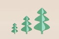 Set of Christmas trees stylish shapes made from green paper, wood. Concept illustration pine on a light beige background, greeting Royalty Free Stock Photo