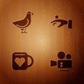 Set Cinema camera, Dove, Coffee cup and heart and Wedding rings on hand on wooden background. Vector