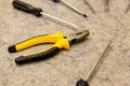 Set circle hand tools pliers screwdriver focus on foreground background close-up background base repairs Royalty Free Stock Photo