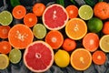 A set of citrus fruit. Orange, tangerine, grapefruit, lemon. On a wooden background.