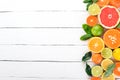 A set of citrus fruit. Orange, tangerine, grapefruit, lemon. On a wooden background.