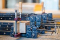 Production process at carpentry workshop, clamps for compression and wooden block laying on table. Royalty Free Stock Photo